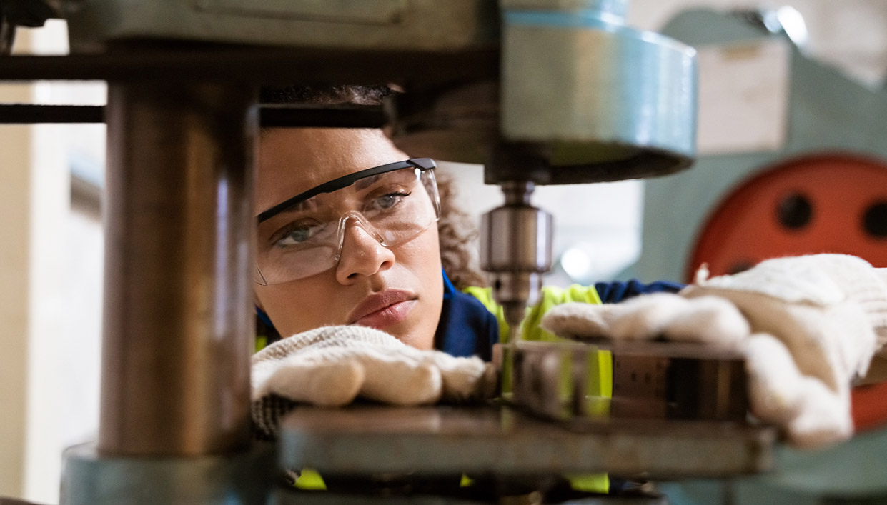 closeup of woman operating manufacturing equipment