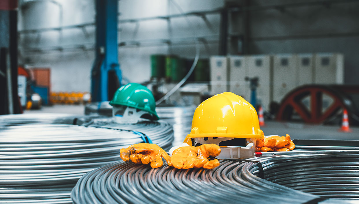 safety equipment like hardhats and gloves laying around in a manufacutring facility